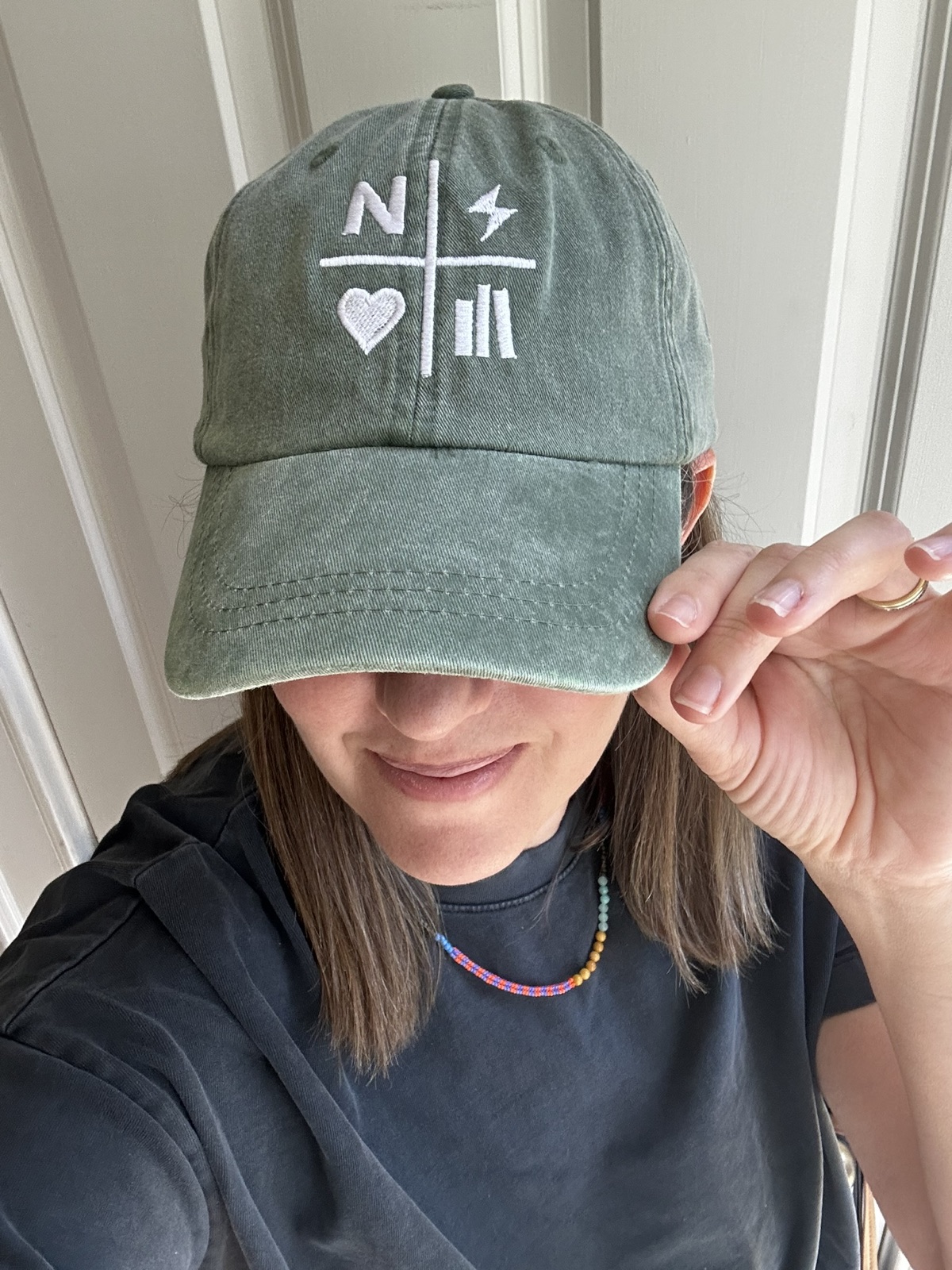 Faded green Nightstand hat being worn