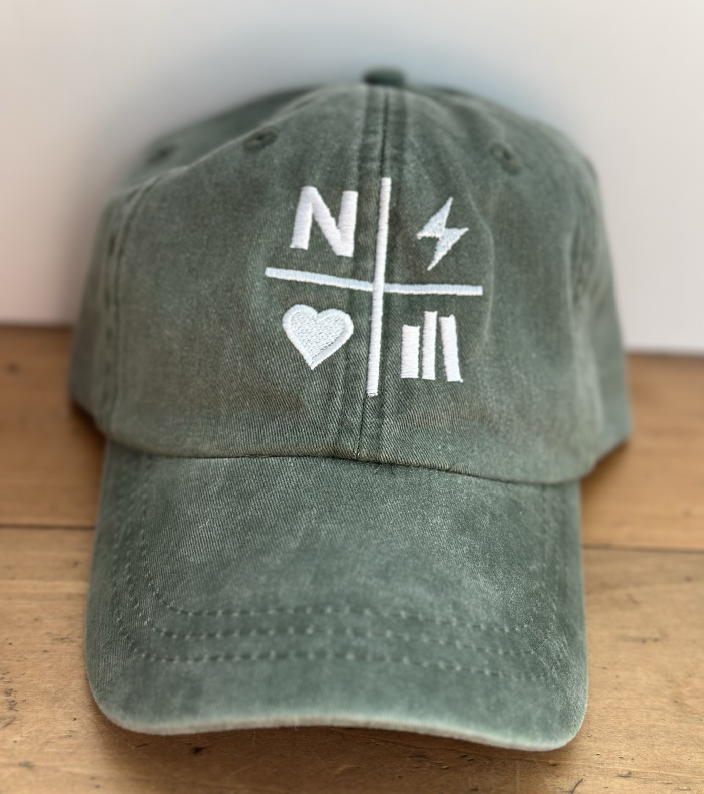 Faded green Nightstand hat with white embroidered logo